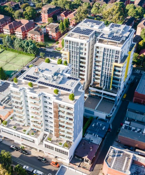 Aerial drone view of arriva’s Strathfield apartments in Sydney featuring rooftop solar panels and modern architecture, highlighting eco-conscious and community-centred living.