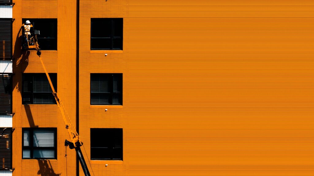 a painter painting an apartment building