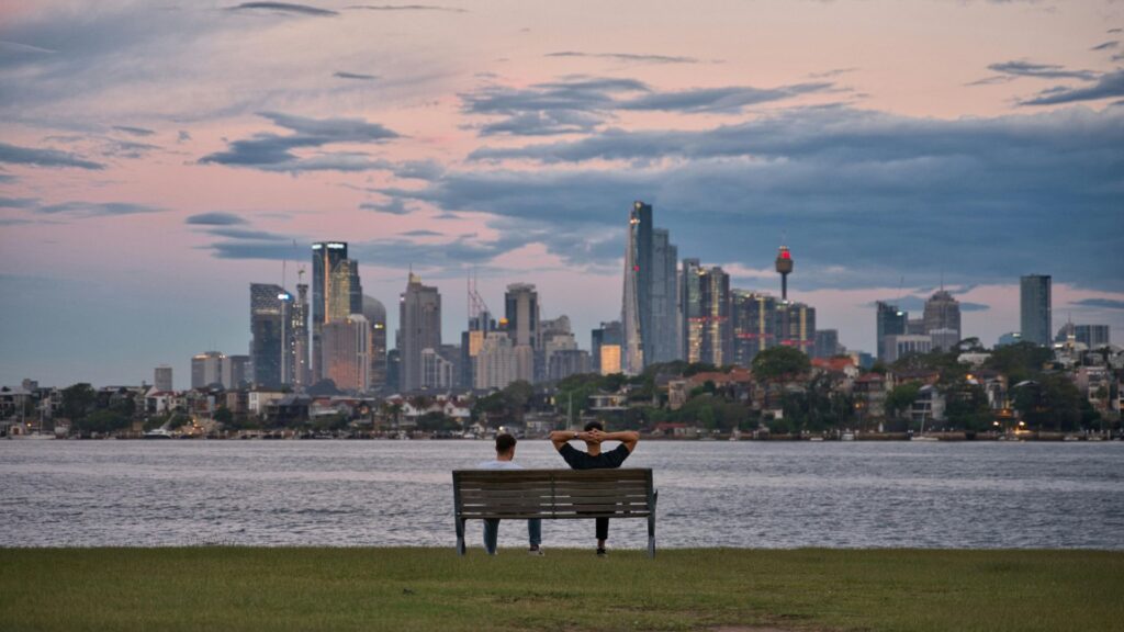 friends on a bench overlooking the lake