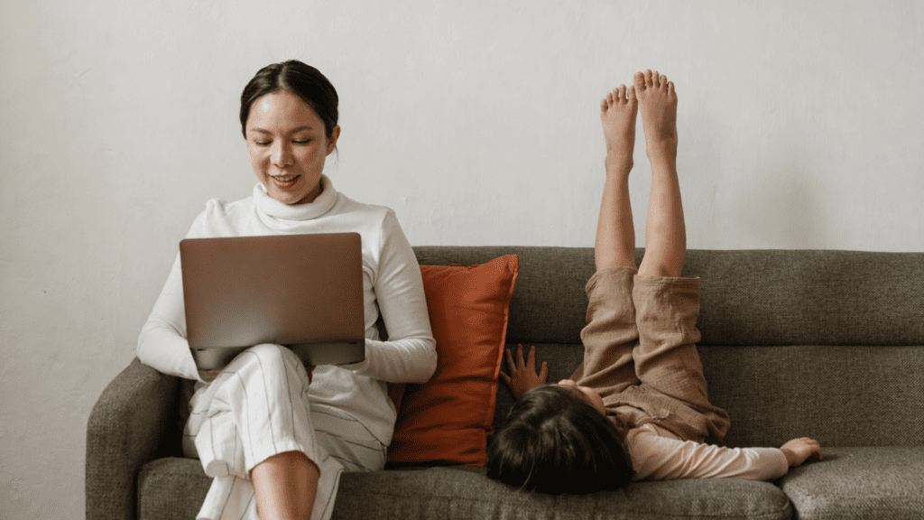 mother working with son on the couch