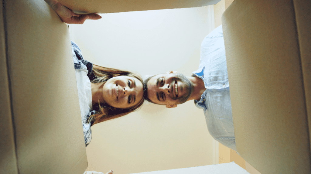 couple unboxing things in their home