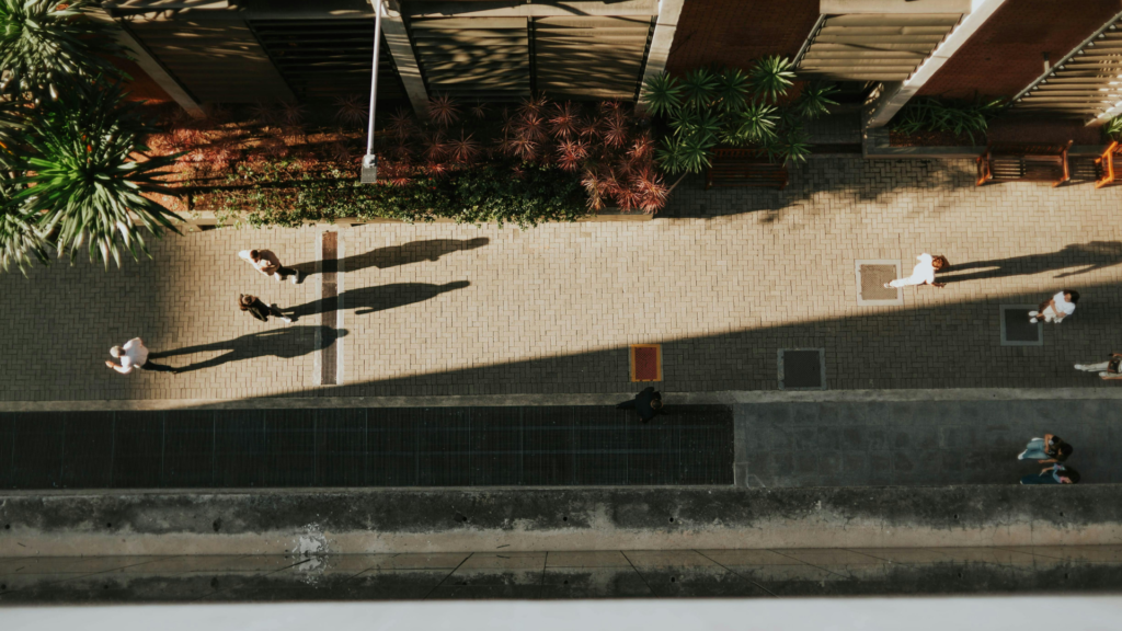 bird's eye view of people walking on a sidewalk